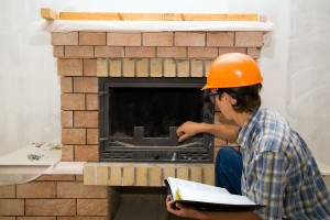 man inspecting fireplace