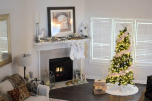 a fireplace with a holiday tree